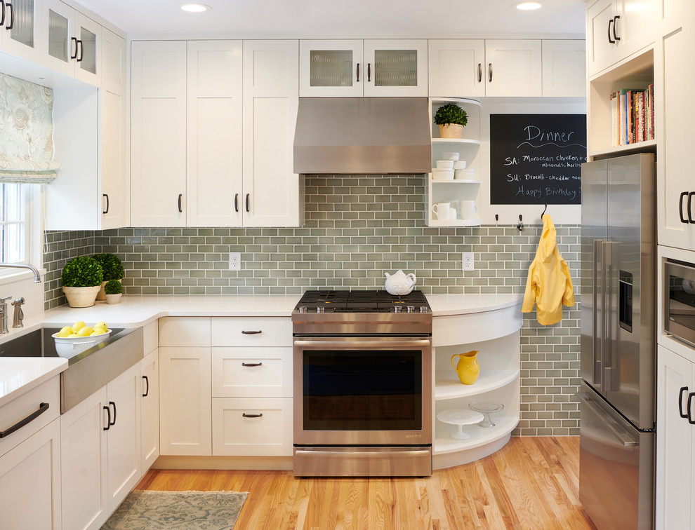 Eat-in kitchen - small transitional u-shaped medium tone wood floor eat-in kitchen idea with a farmhouse sink, shaker cabinets, white cabinets, quartz countertops, blue backsplash, ceramic backsplash, stainless steel appliances, no island and white countertops