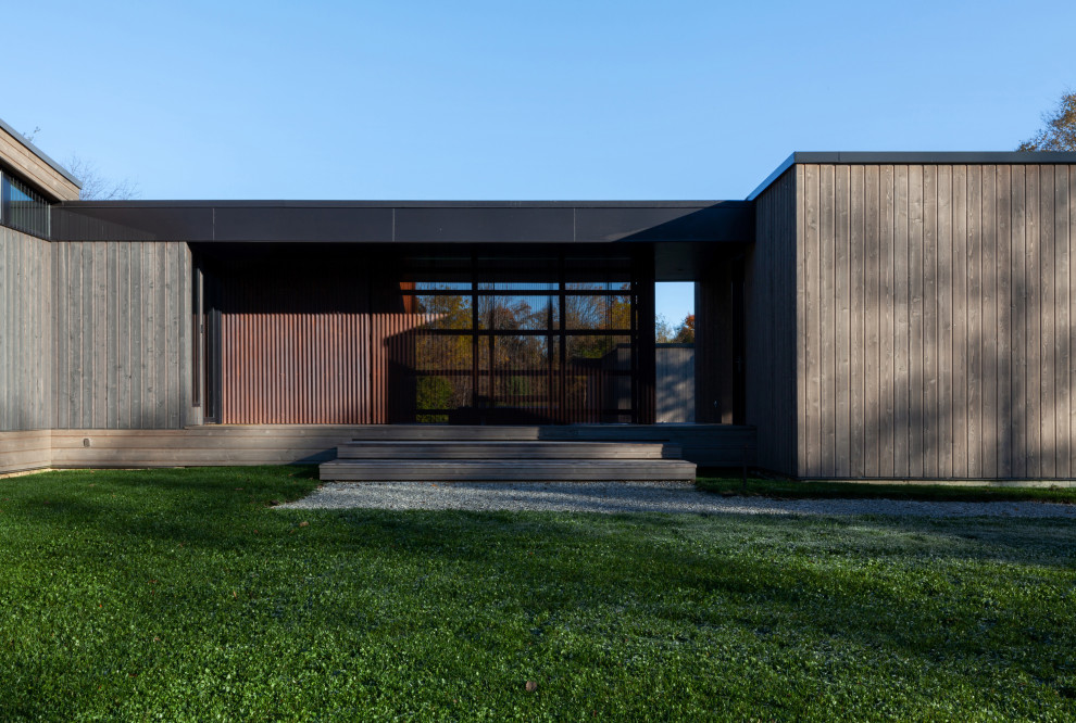 Mid-sized minimalist gray one-story wood and clapboard house exterior photo in Indianapolis with a shed roof, a metal roof and a gray roof