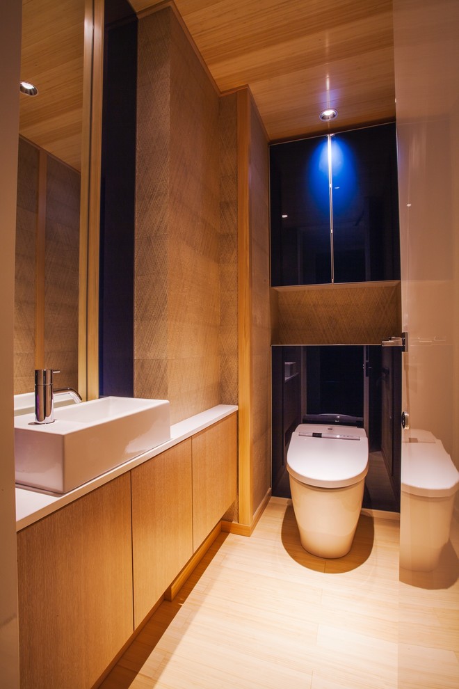 Photo of a contemporary powder room in Other with blue walls and grey floor.