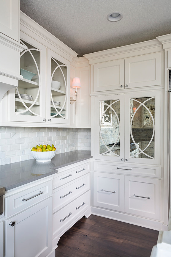 Eat-in kitchen - large transitional u-shaped dark wood floor eat-in kitchen idea in Minneapolis with an undermount sink, recessed-panel cabinets, gray cabinets, marble countertops, white backsplash, stone tile backsplash, paneled appliances and two islands