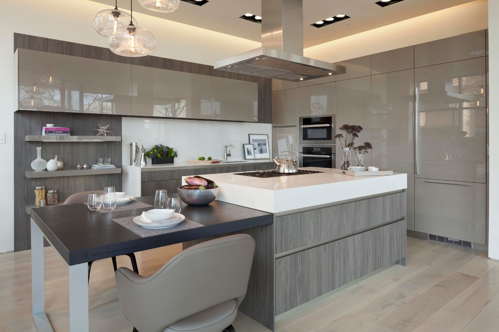 Inspiration for a large modern l-shaped eat-in kitchen in DC Metro with flat-panel cabinets, grey cabinets, wood benchtops, white splashback, with island, an undermount sink, glass sheet splashback, stainless steel appliances, medium hardwood floors and grey floor.