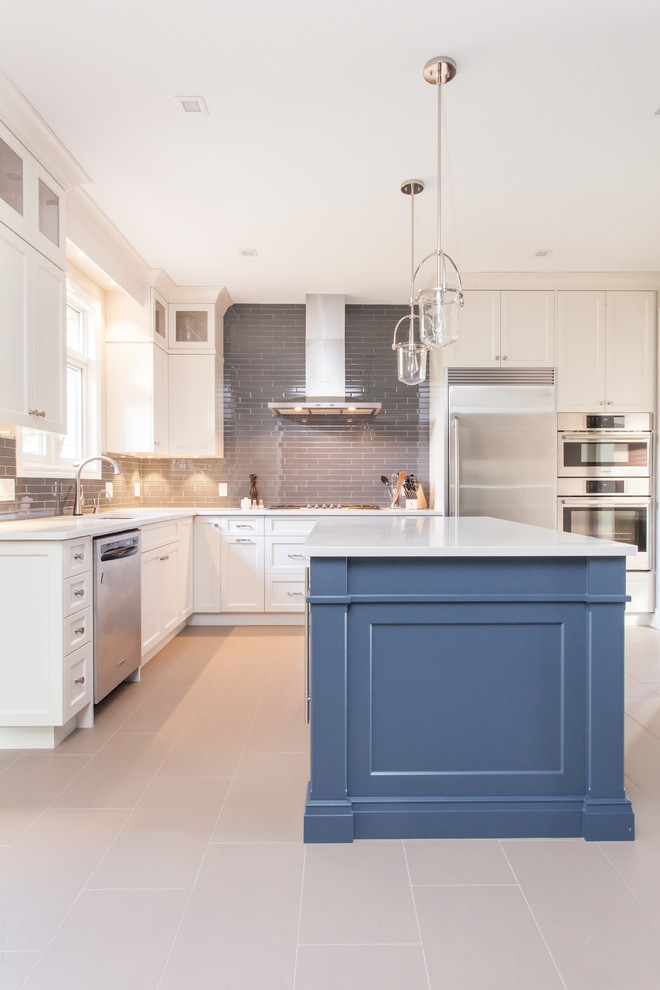 Example of a large transitional u-shaped porcelain tile and gray floor eat-in kitchen design in Toronto with an undermount sink, recessed-panel cabinets, white cabinets, quartz countertops, gray backsplash, subway tile backsplash, stainless steel appliances, an island and white countertops