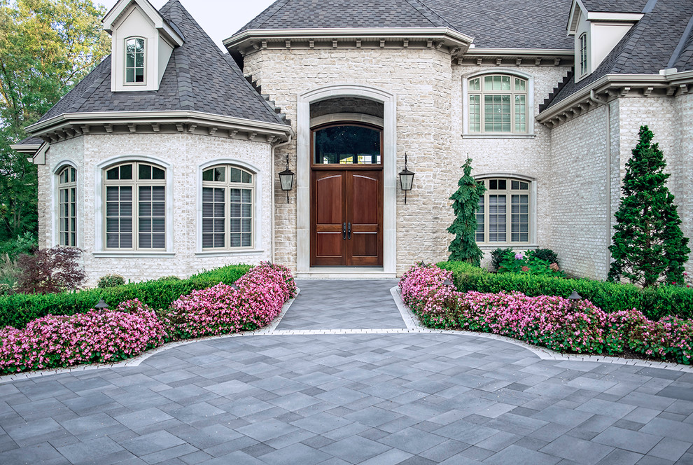 Inspiration for a large mediterranean front yard partial sun driveway in Other with a garden path and natural stone pavers.