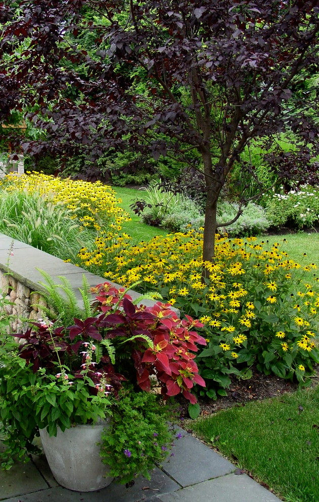 Design ideas for a small traditional backyard full sun garden for summer in Boston with a container garden.