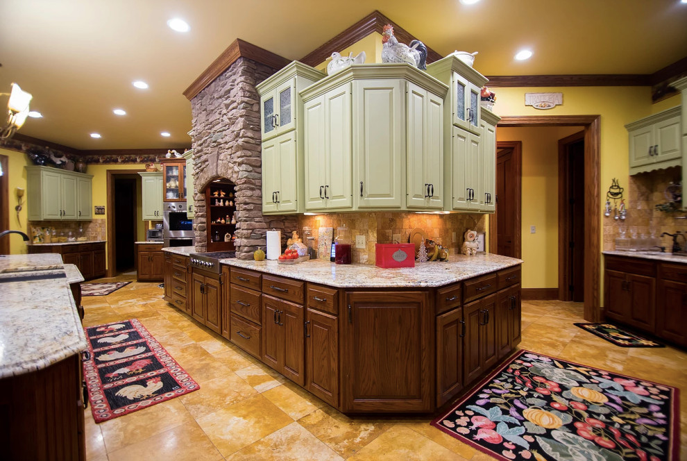 Inspiration for a large rustic u-shaped porcelain tile and beige floor eat-in kitchen remodel with an undermount sink, raised-panel cabinets, green cabinets, granite countertops, beige backsplash, porcelain backsplash, stainless steel appliances, an island and multicolored countertops