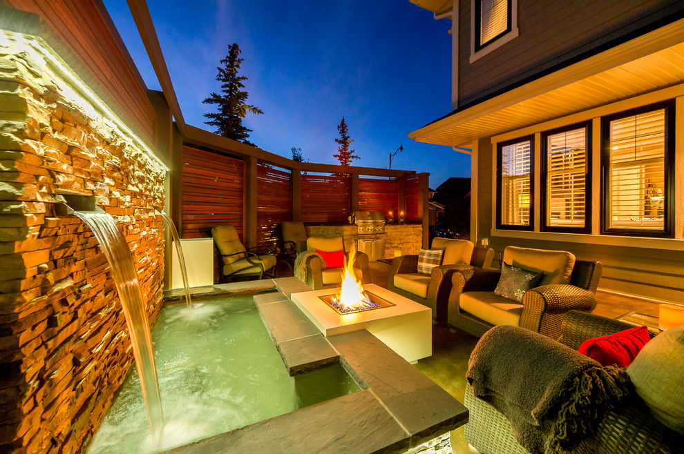 Photo of a mid-sized traditional backyard patio in Calgary with a fire feature.