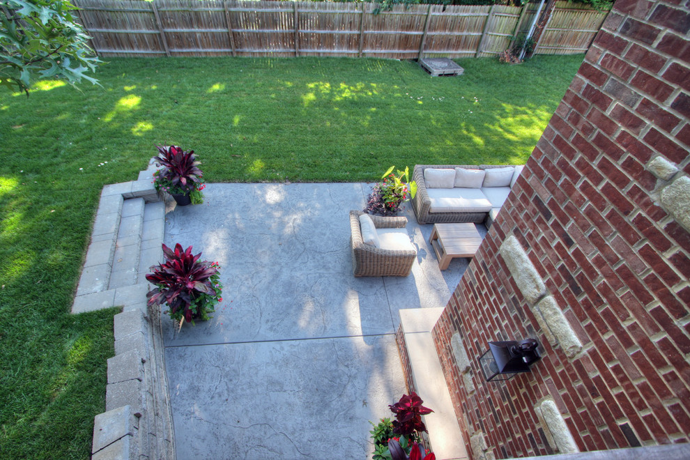 This is an example of a large transitional backyard deck in St Louis with a fire feature and no cover.
