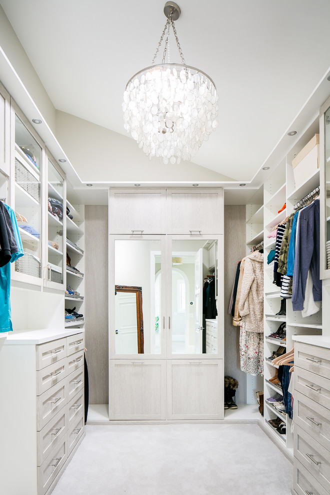 Photo of a transitional walk-in wardrobe in Orange County with shaker cabinets, white cabinets, carpet and white floor.