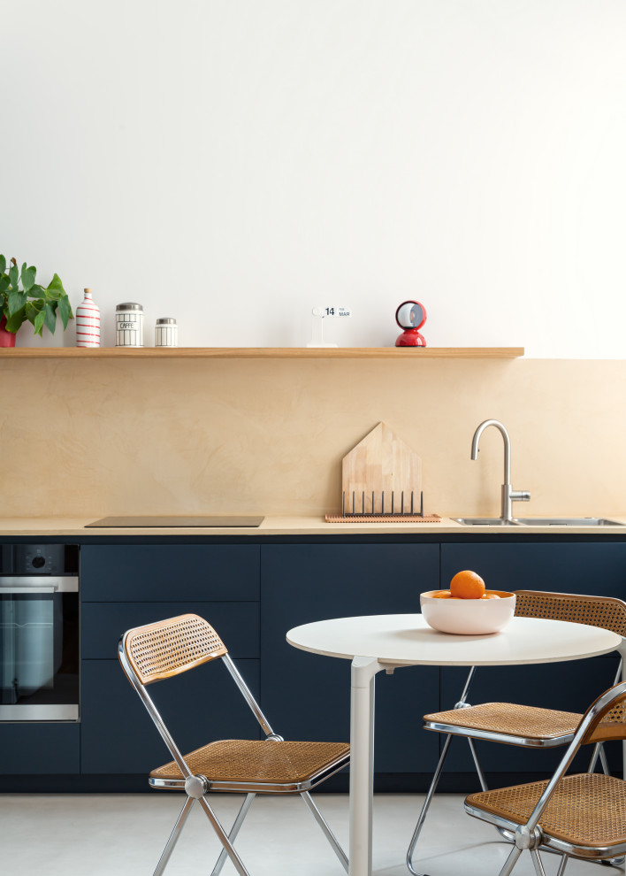 Inspiration for a medium sized contemporary l-shaped open plan kitchen in Milan with flat-panel cabinets, blue cabinets, concrete worktops, yellow splashback, concrete flooring, no island, grey floors and yellow worktops.