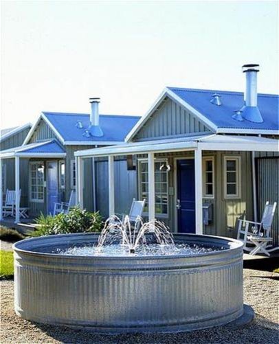This is an example of a country backyard patio in San Francisco with a water feature, gravel and an awning.