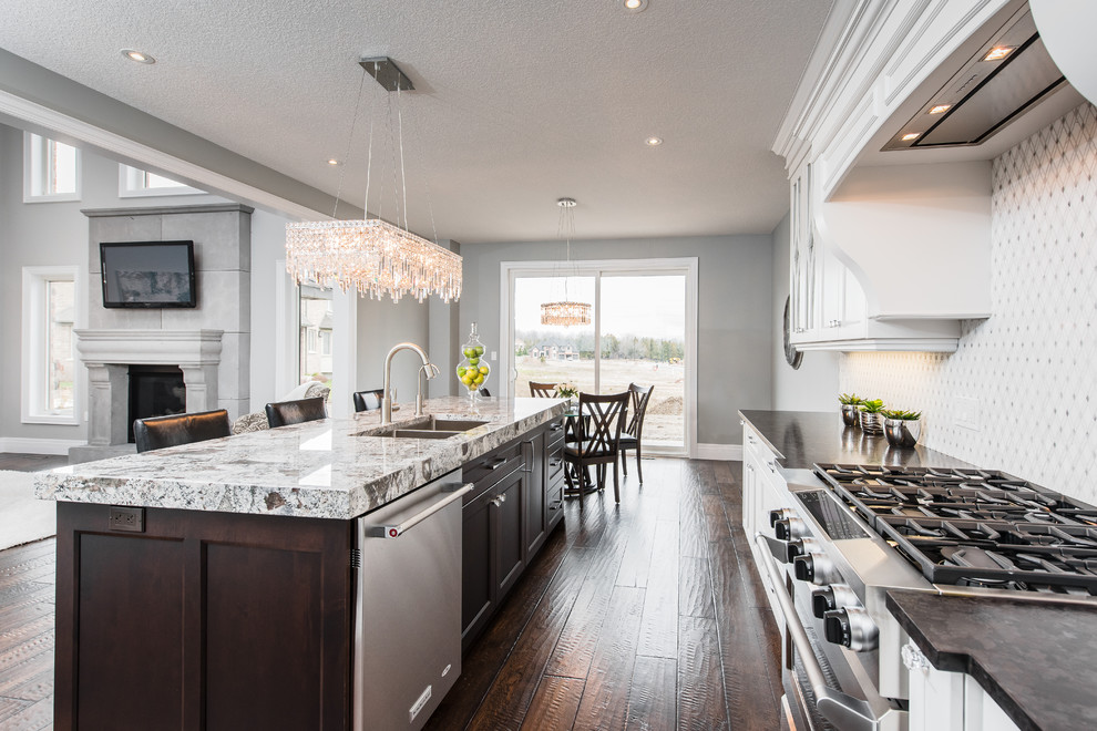 Example of a transitional dark wood floor open concept kitchen design in Toronto with an undermount sink, recessed-panel cabinets, white cabinets, white backsplash, stainless steel appliances and an island