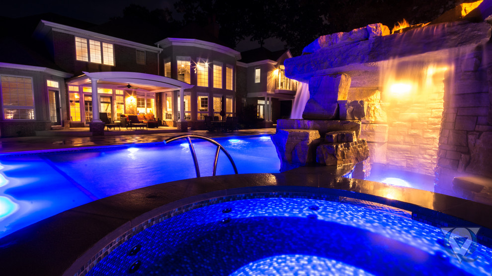 Large mountain style backyard stone and rectangular natural pool fountain photo in Chicago