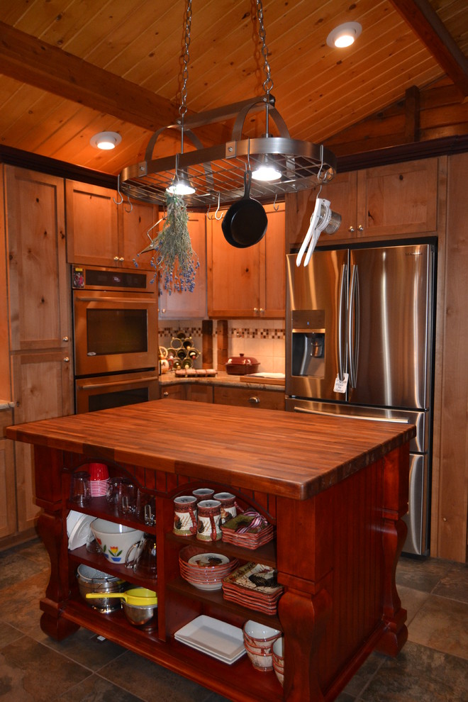 Example of a mountain style kitchen design in Seattle with light wood cabinets
