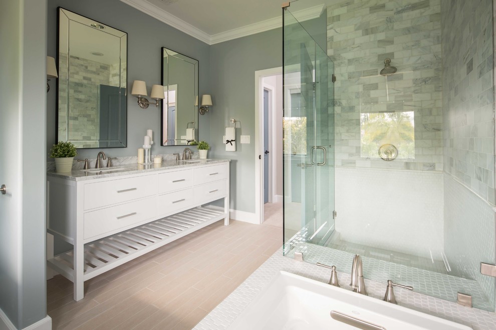 Inspiration for a large contemporary master bathroom in Los Angeles with a console sink, furniture-like cabinets, white cabinets, granite benchtops, a drop-in tub, an open shower, gray tile, stone tile and grey walls.