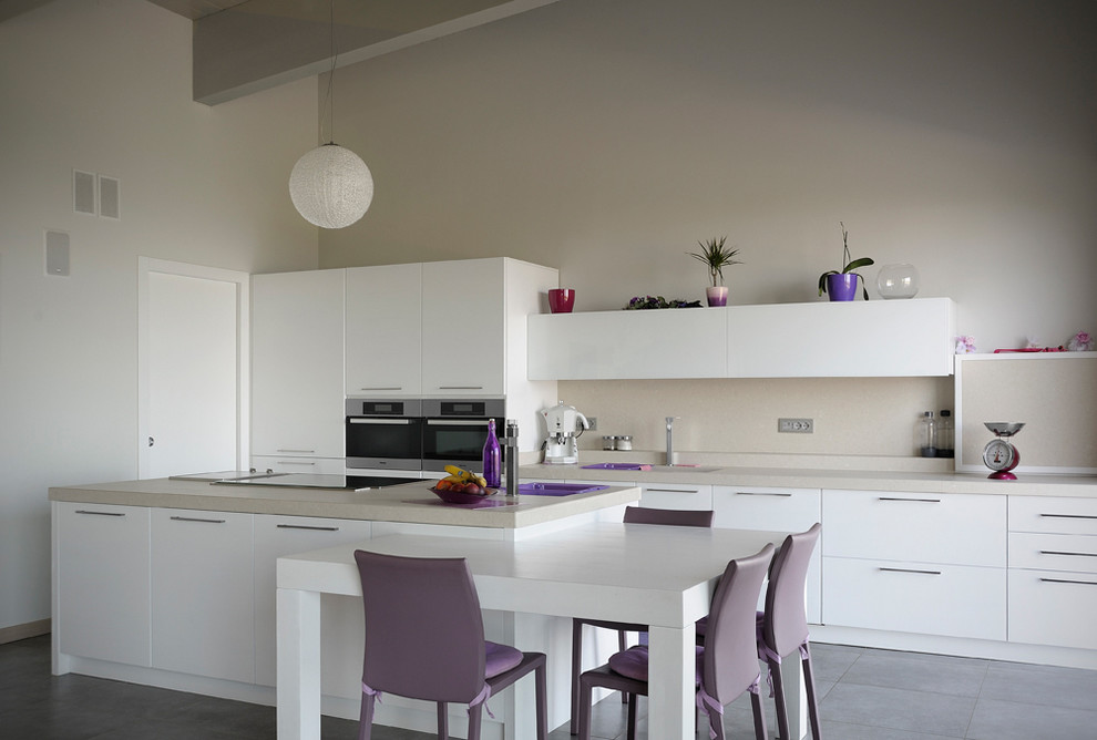 This is an example of a large contemporary galley eat-in kitchen in Bologna with flat-panel cabinets, white cabinets, stainless steel appliances, with island, marble benchtops, beige splashback and ceramic floors.