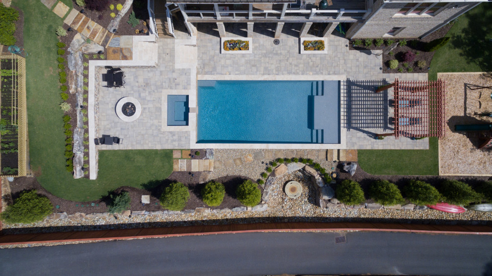 Hot tub - large modern backyard concrete paver and rectangular natural hot tub idea in Atlanta