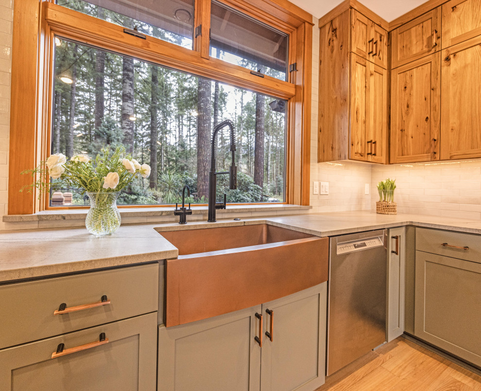 Inspiration for a large rustic u-shaped light wood floor and brown floor eat-in kitchen remodel with a farmhouse sink, shaker cabinets, quartzite countertops, gray backsplash, ceramic backsplash, stainless steel appliances, a peninsula and gray countertops
