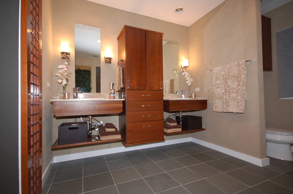 Design ideas for a mid-sized master bathroom in Chicago with an undermount sink, flat-panel cabinets, medium wood cabinets, granite benchtops, a two-piece toilet, beige tile, brown walls and slate floors.