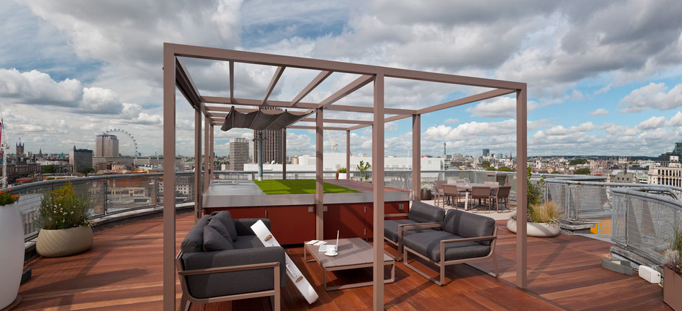 Inspiration for a contemporary rooftop and rooftop deck in London with a pergola and an outdoor kitchen.