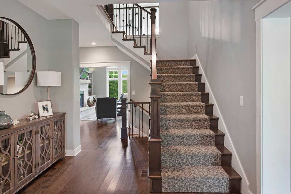 Design ideas for a large country carpeted l-shaped staircase in Kansas City with carpet risers and mixed railing.
