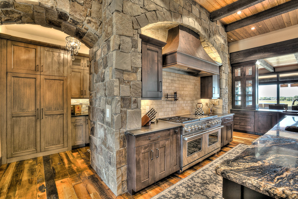 Eat-in kitchen - huge rustic l-shaped medium tone wood floor eat-in kitchen idea in Denver with an undermount sink, shaker cabinets, medium tone wood cabinets, granite countertops, beige backsplash, stone tile backsplash, stainless steel appliances and two islands