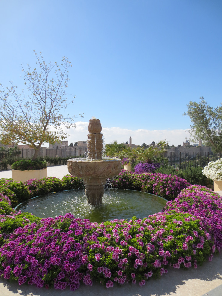 Photo of a traditional garden in Other with a water feature.