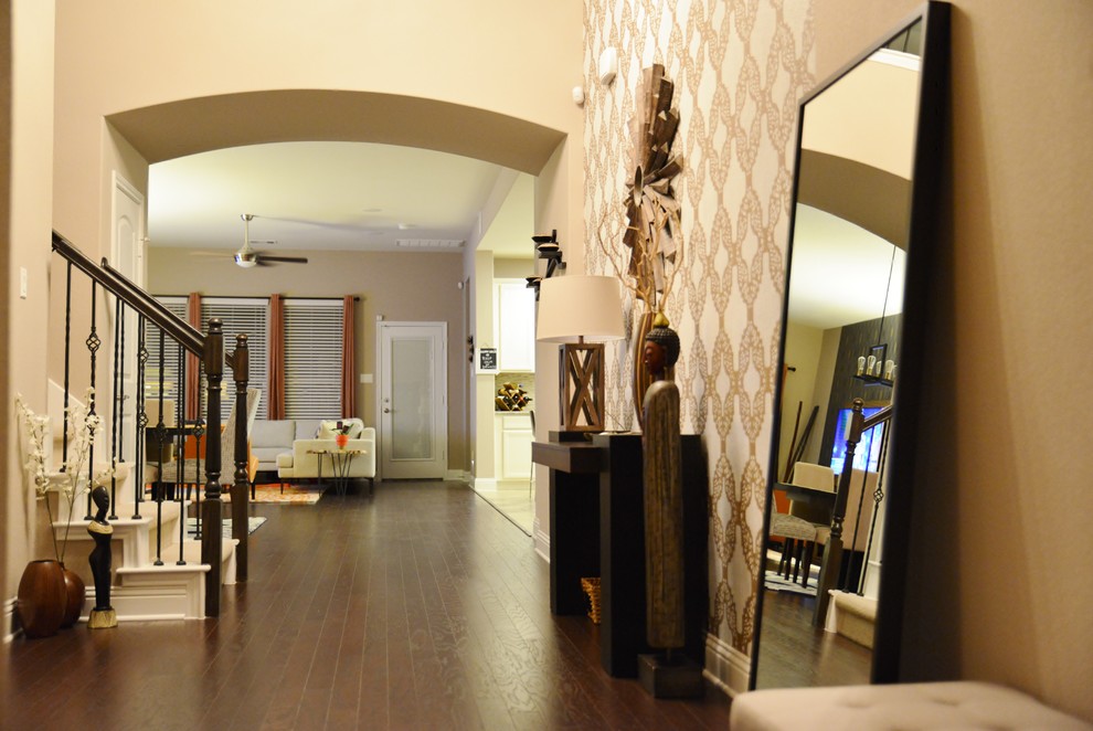 Example of a mid-sized transitional dark wood floor foyer design in Austin with beige walls and a dark wood front door