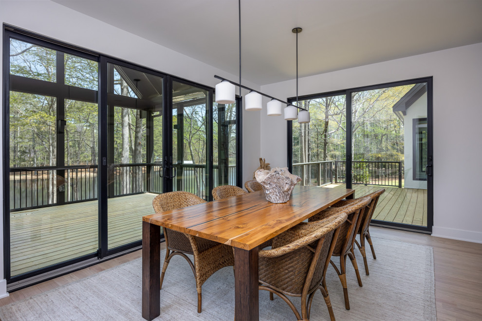 Inspiration for a large transitional medium tone wood floor open concept kitchen remodel in Raleigh with an undermount sink, beaded inset cabinets, white cabinets, quartz countertops, white backsplash, quartz backsplash, paneled appliances, an island and white countertops