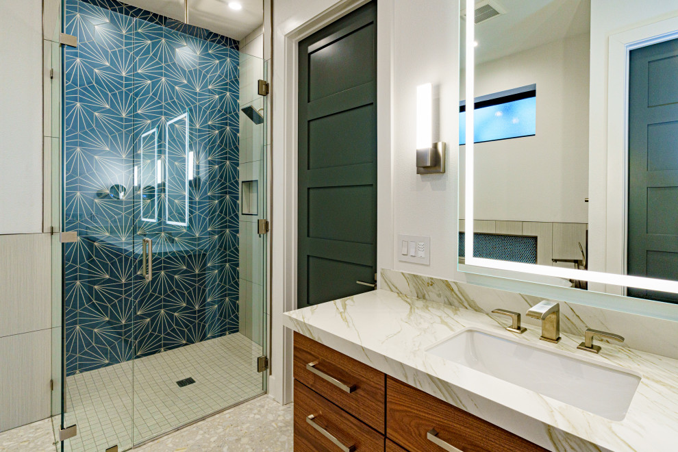 Contemporary master bathroom in Austin with medium wood cabinets, a freestanding tub, a curbless shower, white walls, white floor, a hinged shower door, white benchtops, an enclosed toilet and a double vanity.