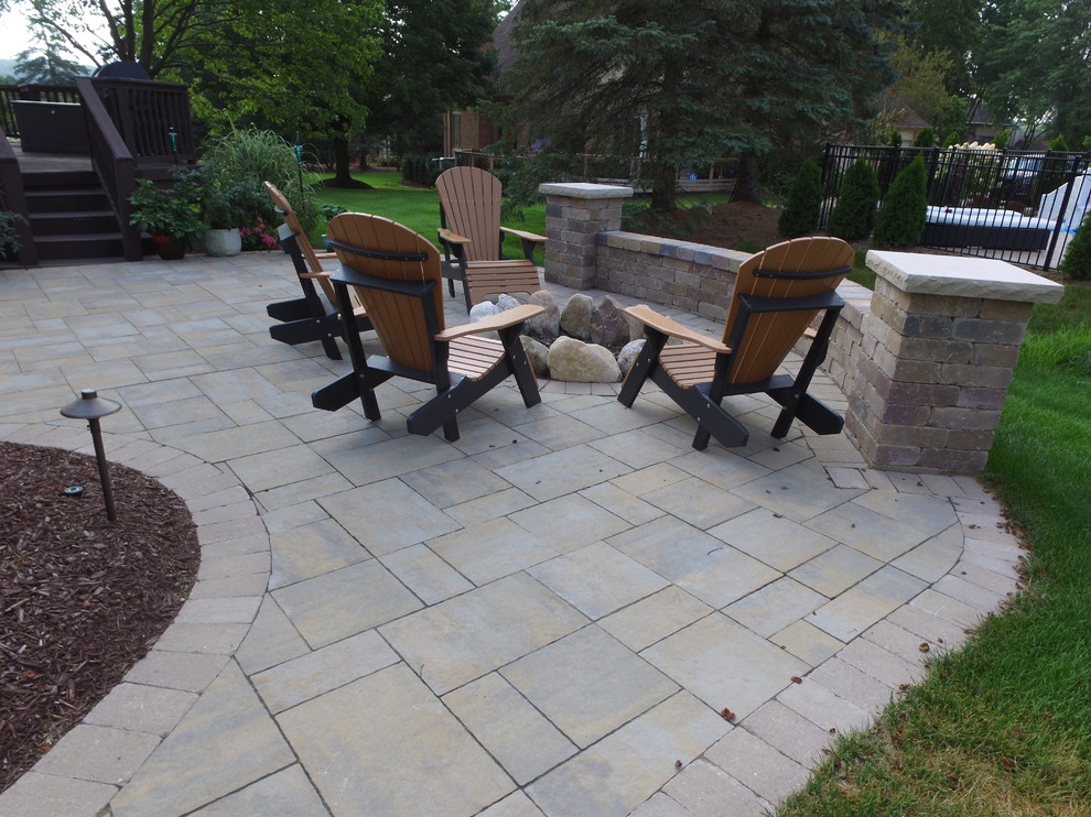 Mid-sized contemporary backyard patio in Detroit with brick pavers.