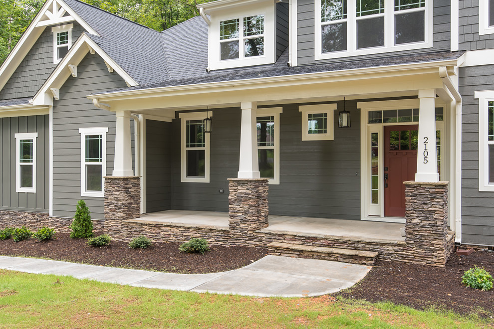 Photo of a mid-sized arts and crafts front yard verandah in Raleigh with concrete slab and a roof extension.
