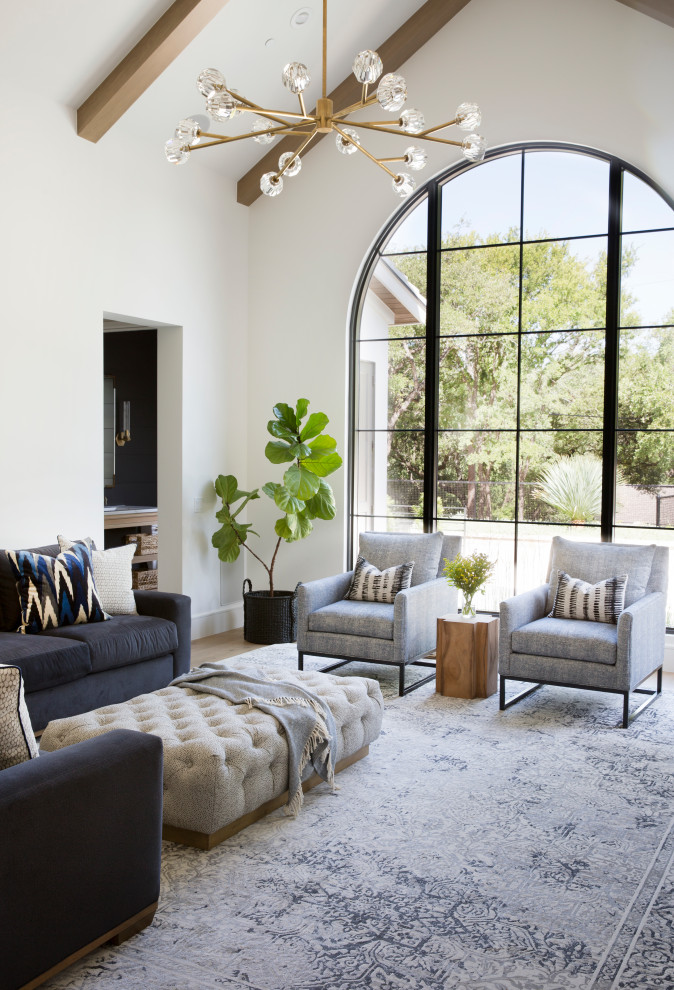 Photo of a large mediterranean formal living room in Austin with white walls and beige floor.