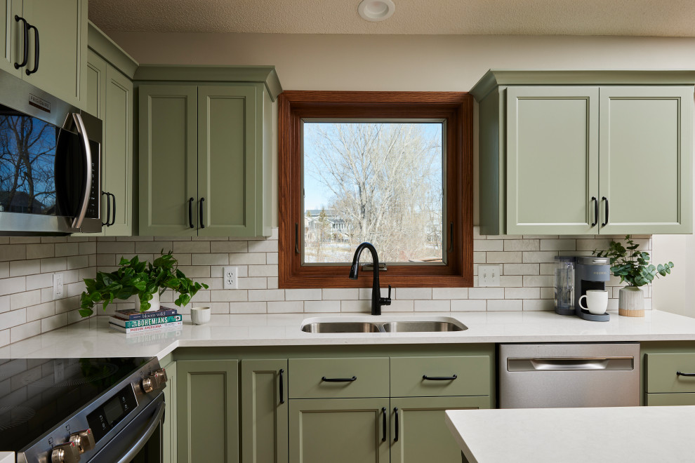 Eat-in kitchen - mid-sized transitional u-shaped vinyl floor and brown floor eat-in kitchen idea in Minneapolis with an undermount sink, shaker cabinets, green cabinets, quartz countertops, white backsplash, ceramic backsplash, stainless steel appliances, an island and white countertops