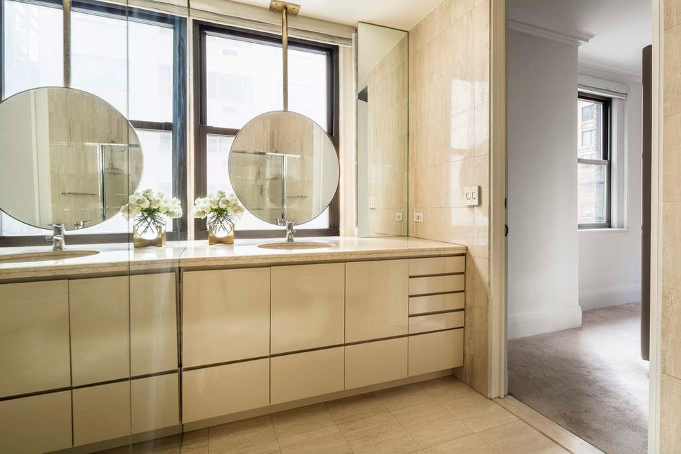 Inspiration for a small transitional master bathroom with flat-panel cabinets, light wood cabinets, a drop-in tub, an open shower, a one-piece toilet, beige tile, marble, beige walls, marble floors, a drop-in sink, marble benchtops, beige floor and beige benchtops.