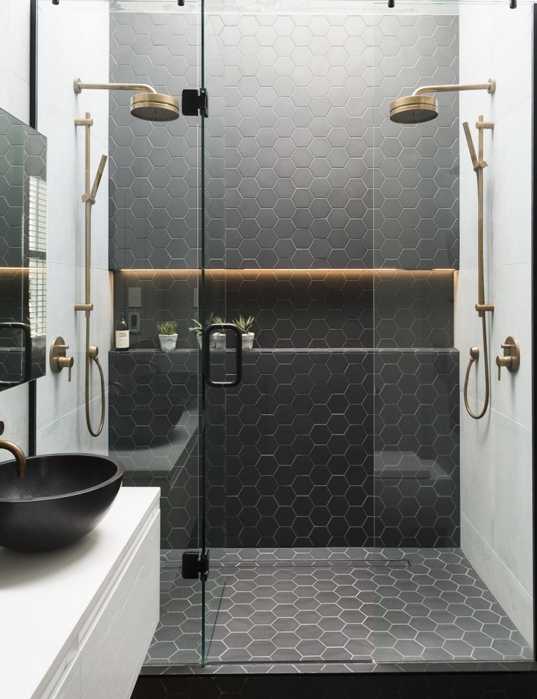 Design ideas for a modern bathroom in Los Angeles with flat-panel cabinets, white cabinets, an alcove shower, white tile, marble, black walls, marble floors, a vessel sink, marble benchtops, black floor, a hinged shower door and white benchtops.