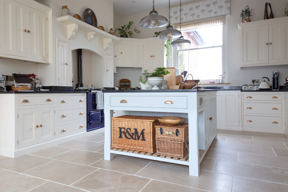 Photo of a mid-sized country u-shaped kitchen in Other with limestone floors, with island and beige floor.