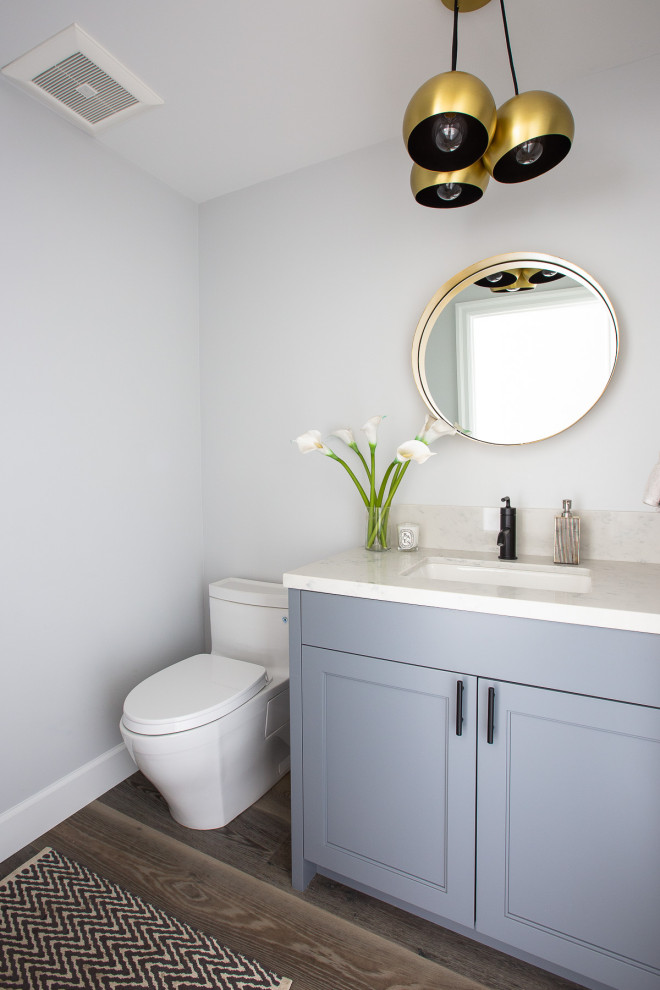 Inspiration for a small transitional powder room in San Francisco with shaker cabinets, grey cabinets, a one-piece toilet, white tile, stone slab, grey walls, medium hardwood floors, an undermount sink, quartzite benchtops, grey floor, white benchtops and a built-in vanity.