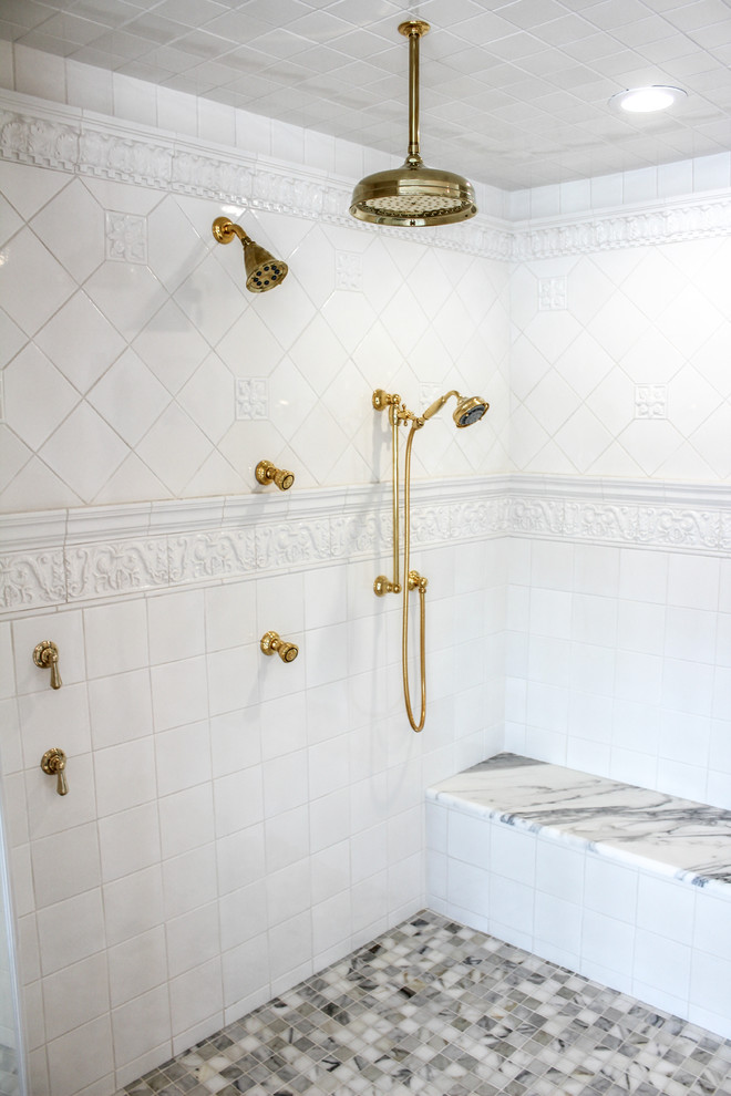 Large traditional master bathroom in New York with a drop-in sink, marble benchtops, raised-panel cabinets, white cabinets, a freestanding tub, an alcove shower, a two-piece toilet, gray tile, multi-coloured tile, white tile, mosaic tile, white walls and marble floors.