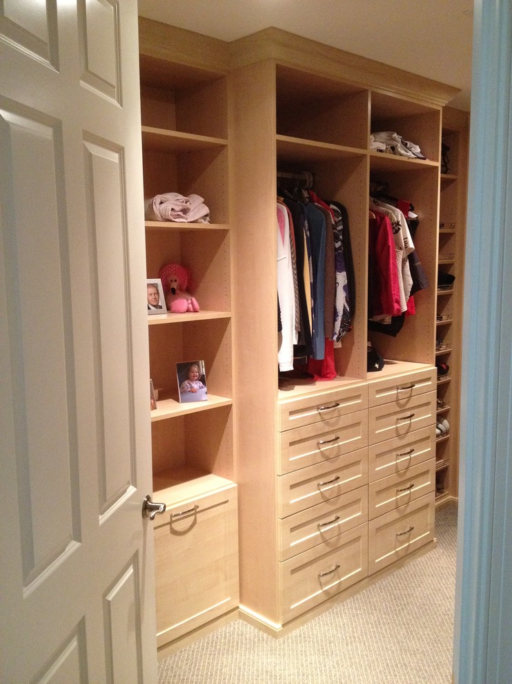 This is an example of a mid-sized traditional women's walk-in wardrobe in Miami with recessed-panel cabinets and white cabinets.