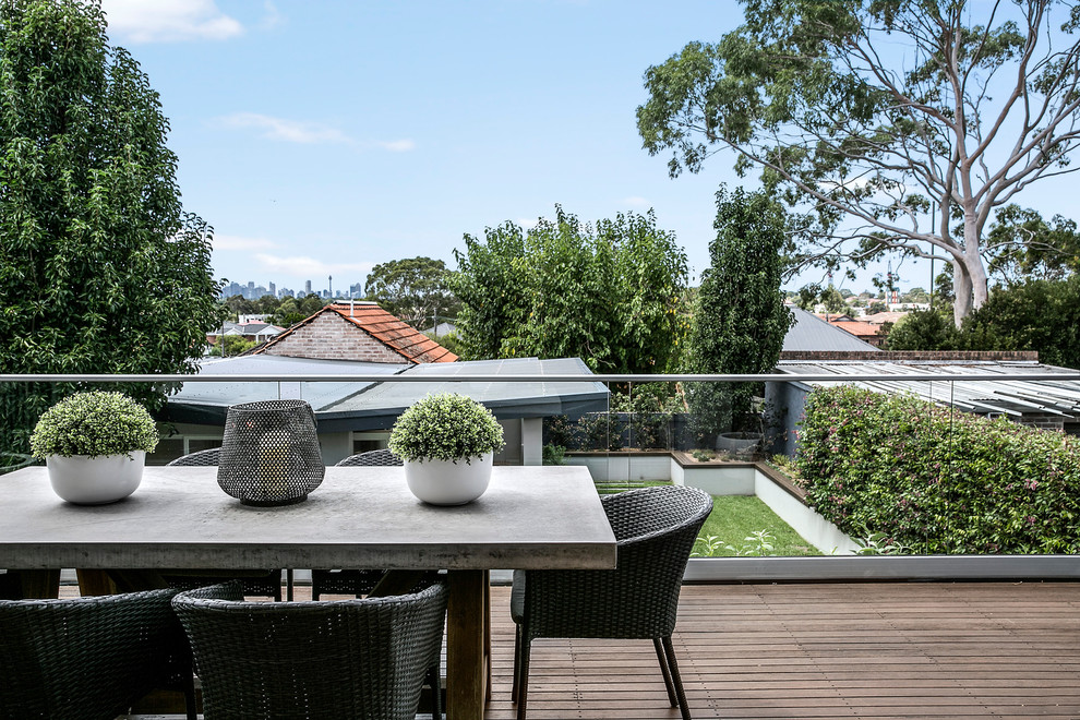 Mid-sized contemporary backyard deck in Sydney with no cover.