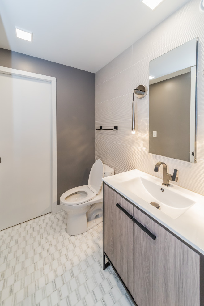 Photo of a modern bathroom in Chicago with light wood cabinets, a drop-in tub, a one-piece toilet, white walls, an open shower and white benchtops.