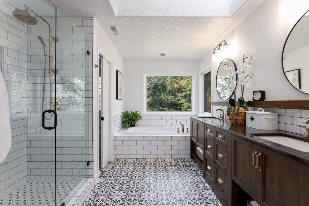 Design ideas for a small transitional 3/4 bathroom in Portland with recessed-panel cabinets, medium wood cabinets, a drop-in tub, an open shower, a two-piece toilet, gray tile, porcelain tile, grey walls, porcelain floors, an undermount sink, engineered quartz benchtops, black floor, an open shower, grey benchtops, an enclosed toilet, a double vanity and a freestanding vanity.