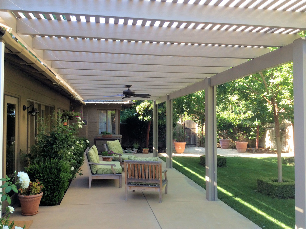 Design ideas for a mid-sized arts and crafts backyard patio in Other with concrete slab and a pergola.