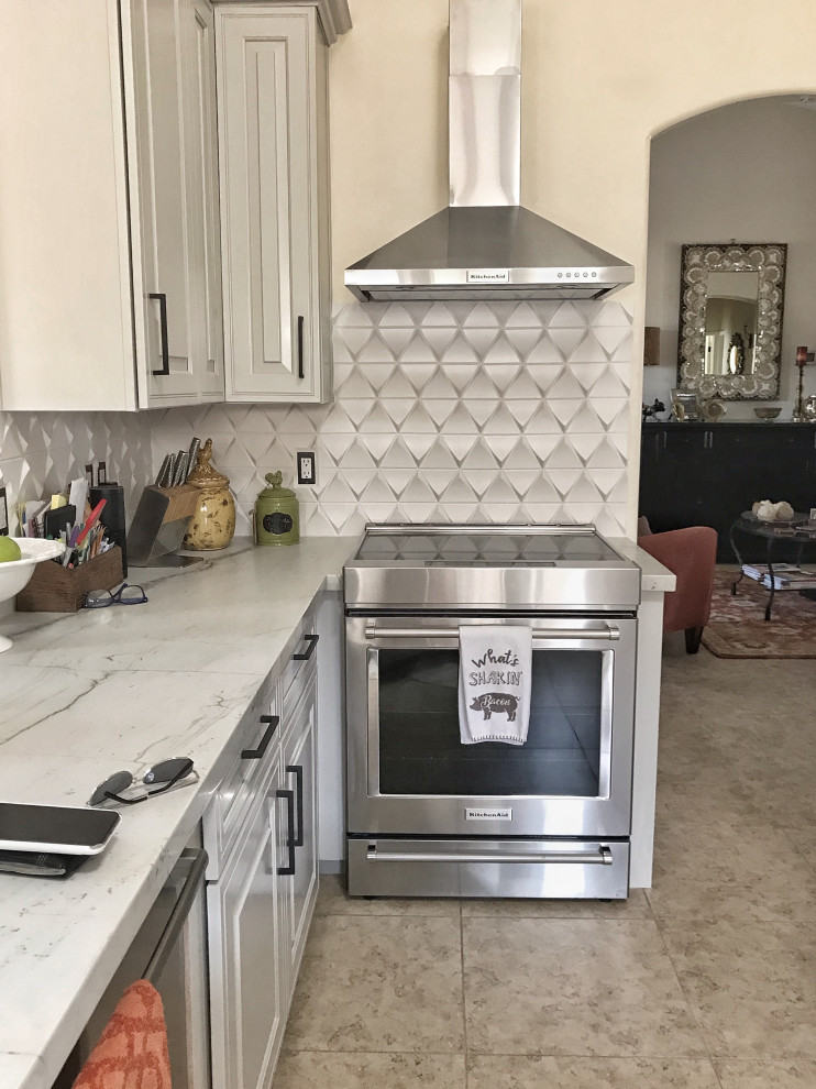 Photo of a small transitional galley eat-in kitchen in Phoenix with a farmhouse sink, raised-panel cabinets, white cabinets, quartz benchtops, white splashback, porcelain splashback, stainless steel appliances, travertine floors, a peninsula, beige floor and white benchtop.