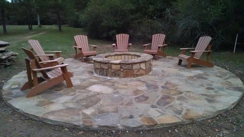 Example of a mid-sized mountain style backyard stone patio design in Houston with a fire pit and no cover