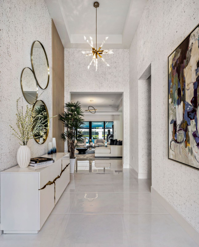 Inspiration for a contemporary porcelain tile, coffered ceiling, wallpaper and white floor foyer remodel in Miami with white walls