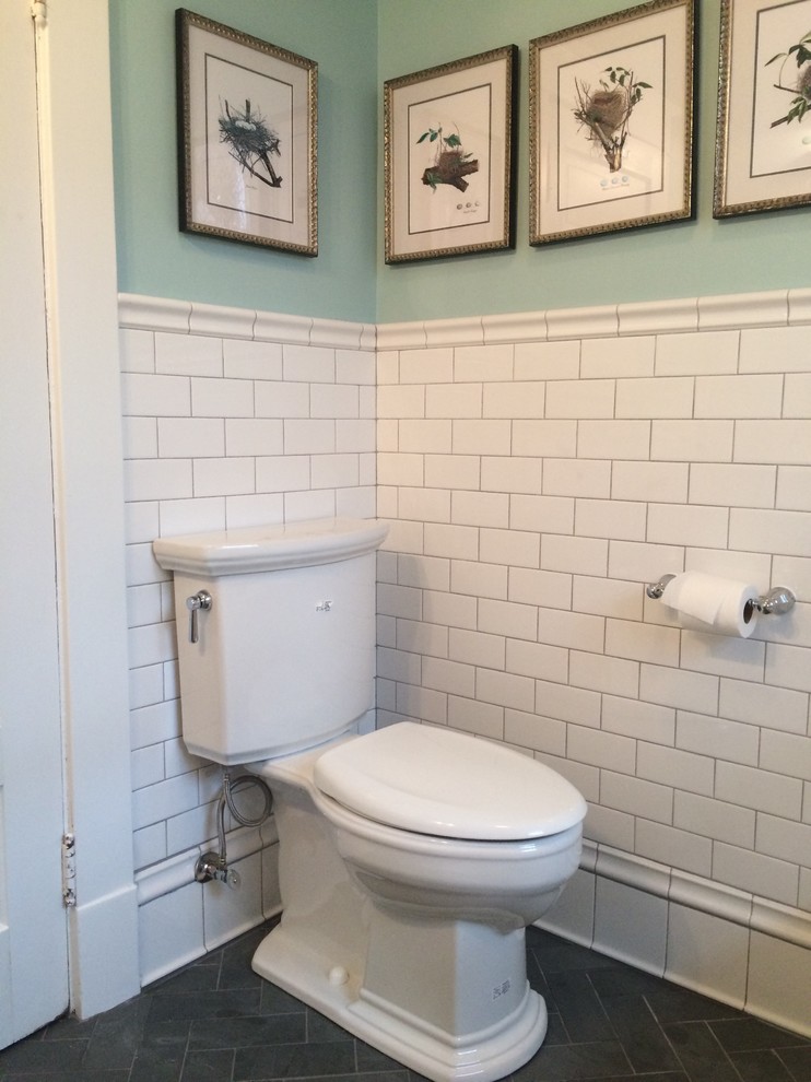 Inspiration for a small traditional powder room in Other with a two-piece toilet, white tile, ceramic tile, green walls, slate floors and a console sink.