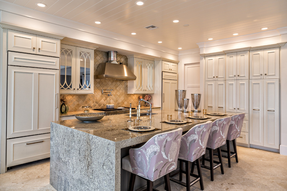 This is an example of a transitional galley eat-in kitchen in Miami with an undermount sink, recessed-panel cabinets, white cabinets, beige splashback and panelled appliances.