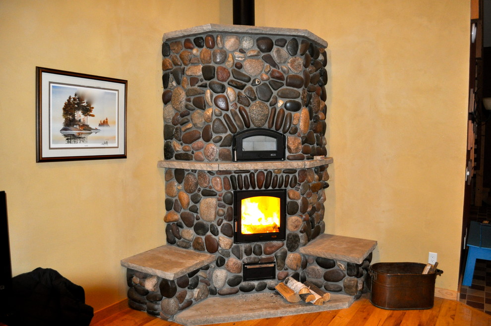 Design ideas for a country living room in San Diego with a wood stove and a stone fireplace surround.