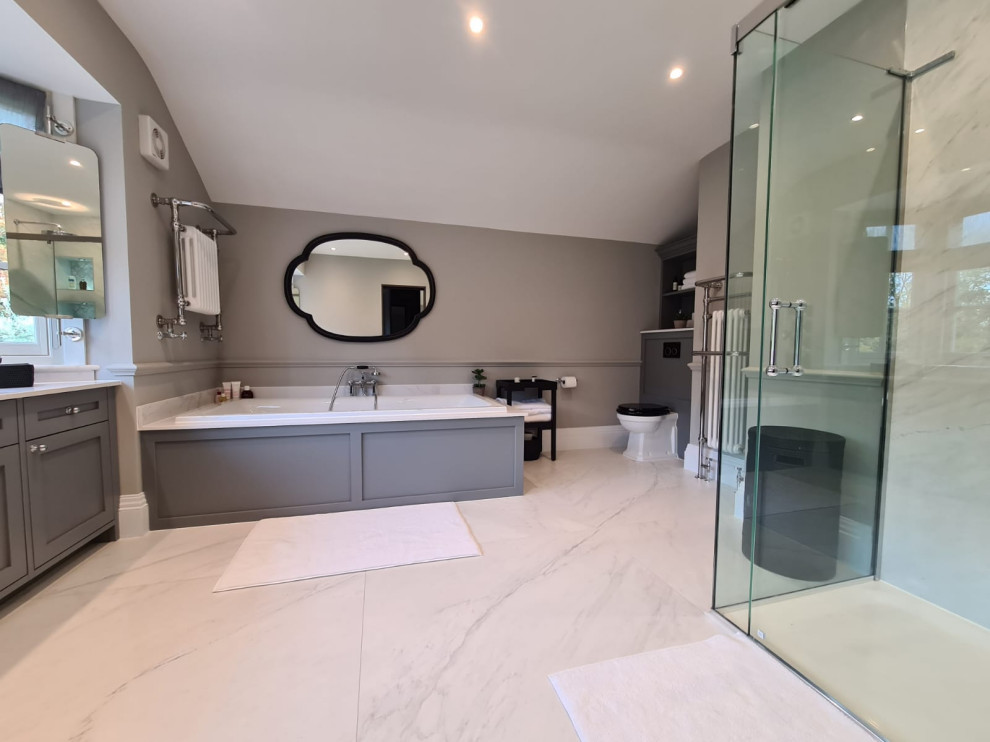 Inspiration for a large traditional ensuite bathroom in London with shaker cabinets, grey cabinets, a built-in bath, porcelain tiles, quartz worktops, double sinks and a built in vanity unit.
